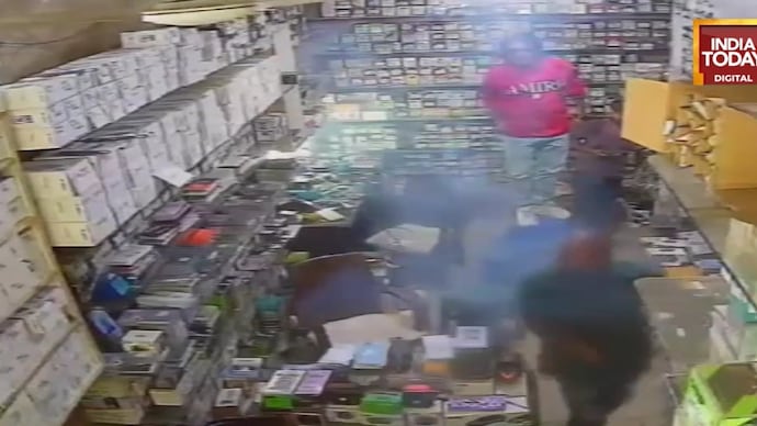 CCTV footage shows the moment a mobile phone exploded inside a shop in Delhi's Jahangirpuri, sending customers and the shopkeeper rushing to safety. Phone explodes inside Jahangirpuri mobile shop, incident caught on CCTV