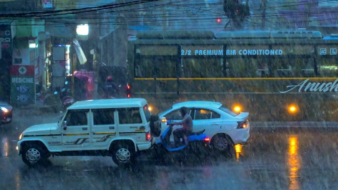 Vehicles ply on a road amid rain, in Cuttack, Odisha. (Photo: PTI) Rain to lash Rajasthan, Maharashtra; showers likely across country on Friday