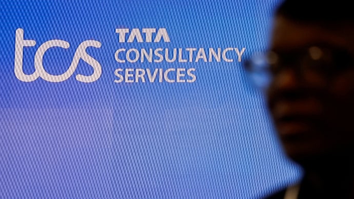 A man walks past a logo of Tata Consultancy Services (TCS) before a press conference announcing the company's quarterly results in Mumbai, India, January 11, 2024