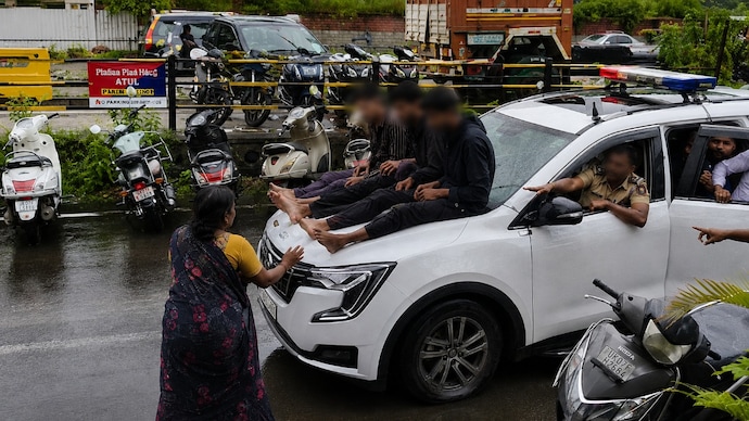 The accused were paraded on the bonnet of the police vehicle