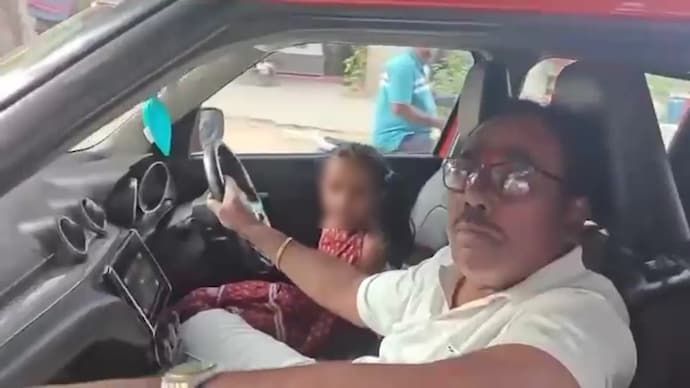 The Sub Inspector Pujari Thirupathi and his grandaughter while driving the Maruti Swift in Hyderabad.