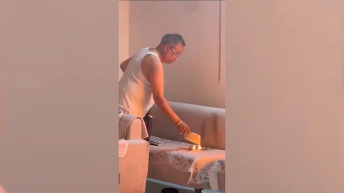 The viral video, circulating widely on social media, allegedly shows businessman Mukesh Gupta placing pieces of newspaper on a sofa before setting them alight.