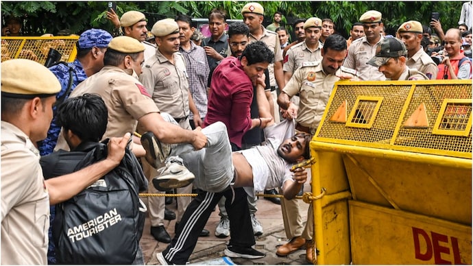 Police personnel detain protesters during a protest at Jantar Mantar demanding the resignation of Union Education Minister Dharmendra Pradhan over alleged irregularities in the NEET examination