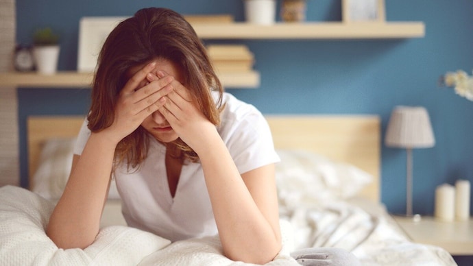 Unhappy girl in a bedroom