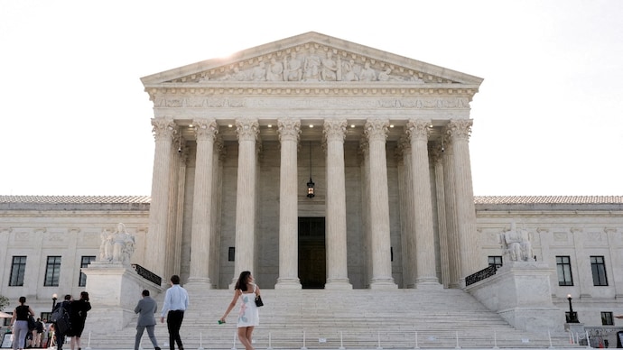 People walk in front of US Supreme Court building. (File Photo: Reuters) People walk in front of the Supreme Court building