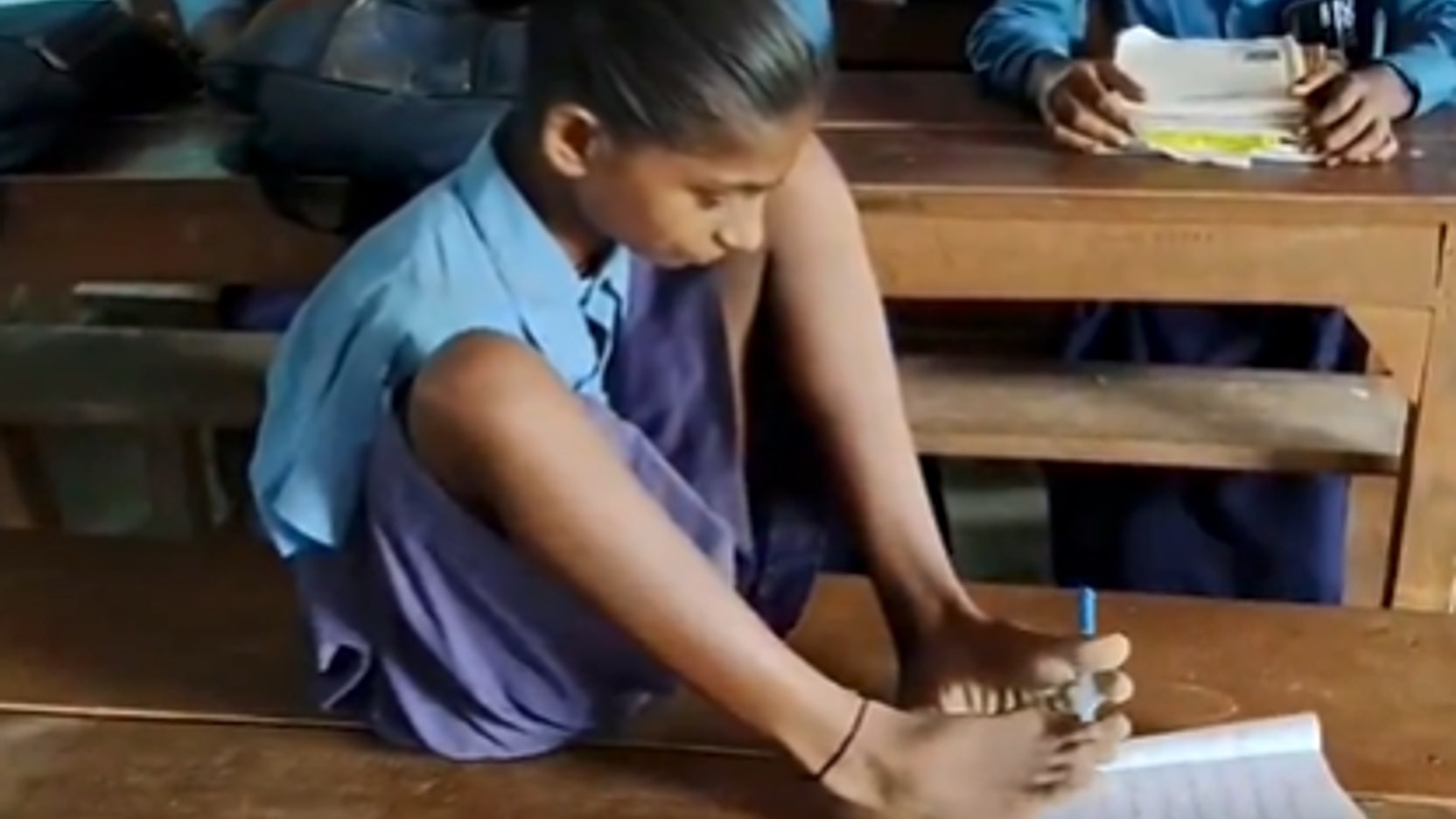 13-year-old Lakshmi writes with her feet, refuses to let disability stop her