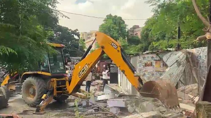 Bulldozer razes illegal chambers of lawyers in Lucknow during civic body's encroachment removal drive. (Source: ITG)
