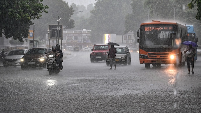 Vehicles wade during monsoon showers near Connaught Place. (Image: PTI)