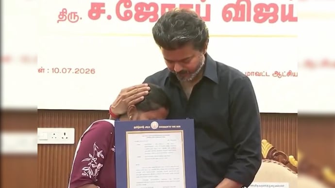 Vijay with a family member of a Karur stampede victim.