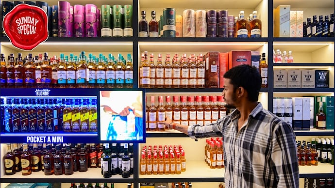 A man browses the shelves of a liquor shop in Prayagraj, Uttar Pradesh. (PTI Photo) A man browses the shelves of a liquor shop in Prayagraj, Uttar Pradesh. (PTI Photo)