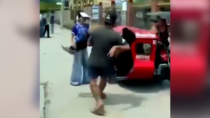 A man carrying an injured student after school shooting