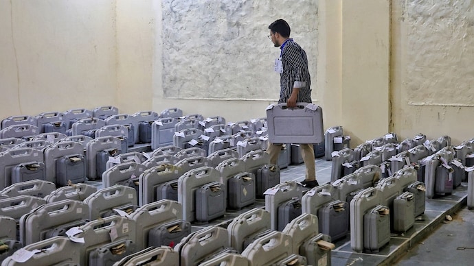 A polling official places the EVMs and VVPATs during the counting of votes for the Rajasthan urban local body elections. (PTI) A polling official places the EVMs and VVPATs during the counting of votes for the Rajasthan urban local body elections. (PTI)