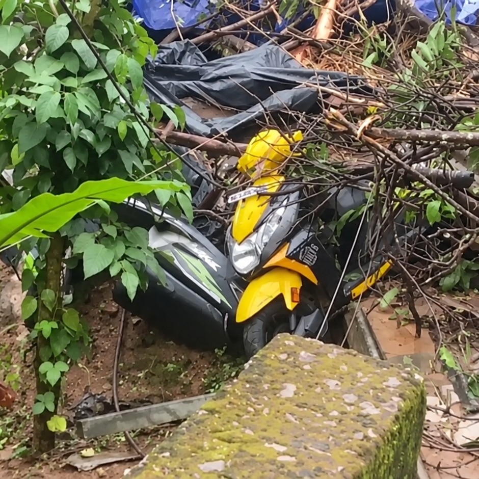A woman was killed after a landslide fell on her scooter.