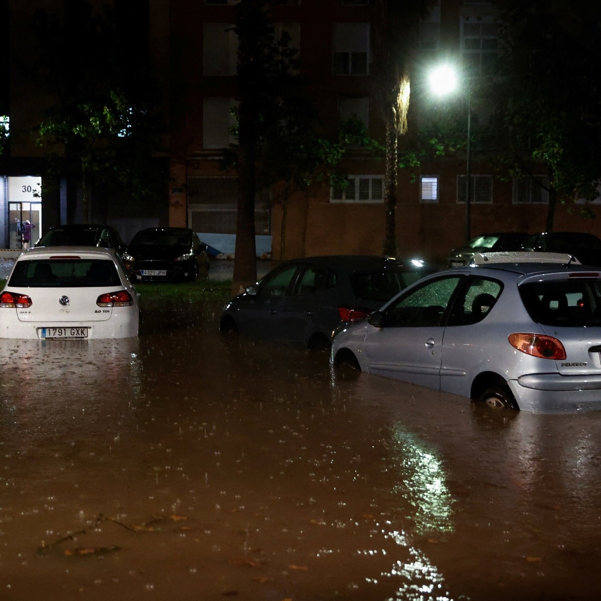 Heavy rain floods Barcelona streets, traps car in tunnel, woman swept away