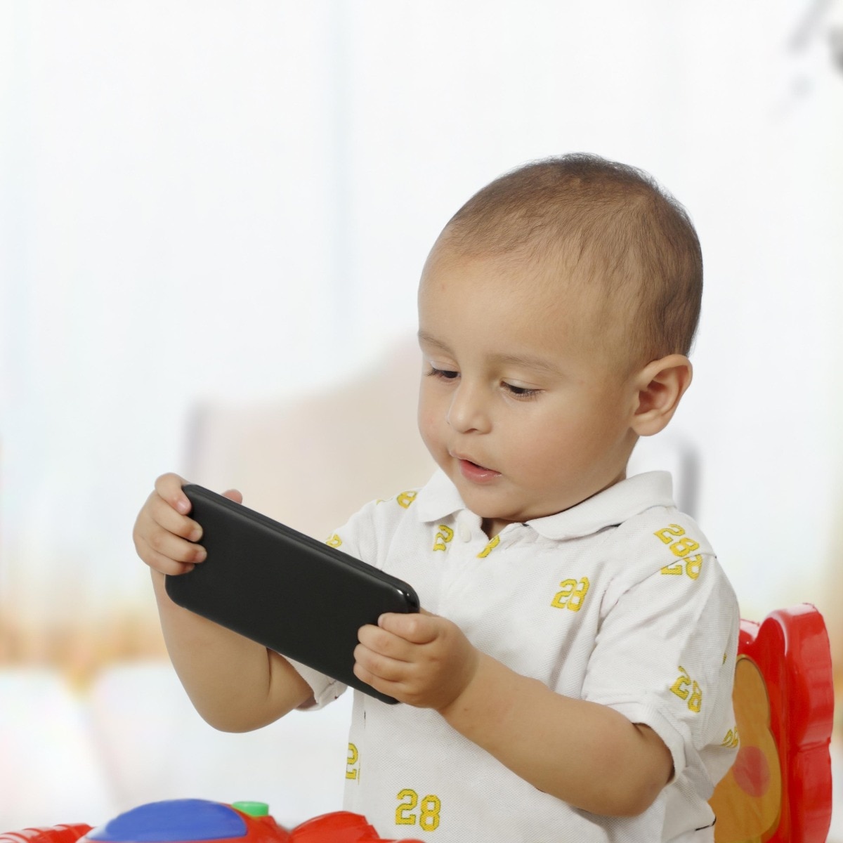 Cute baby boy with phone