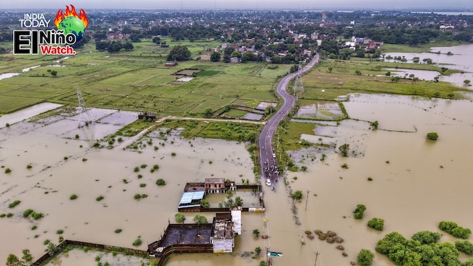 People attempt to cross a submerged road as Badra Sounalti village was inundated after the water level of Ganga river rises following rain, in Prayagraj. (Photo: PTI) El Nino watch