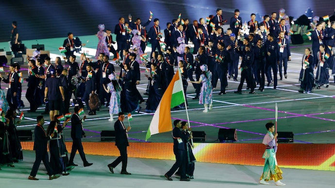 Flag bearers Manu Bhaker and Pawan Sehrawat lead out athletes of India in the athletes' parade (Reuters Photo) Flag bearers Manu Bhaker and Pawan Sehrawat