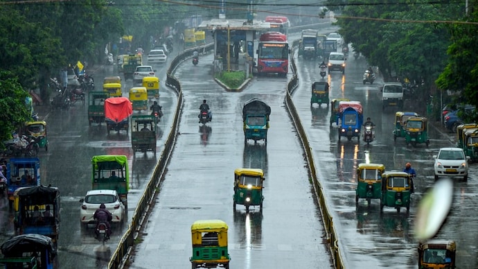 Commuters make their way amid rainfall, in Ahmedabad, Gujarat. (Photo: PTI) Four Indian cities among world's 20 least resilient to climate extremes: Report