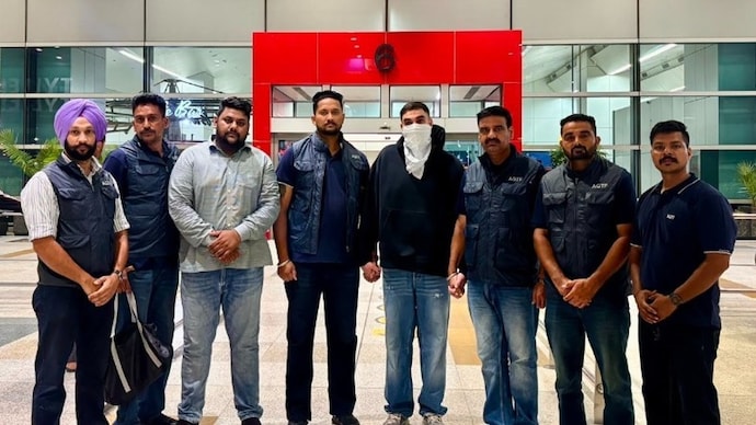 Karamveer Singh with Punjab Police officials at the Delhi Airport. Karamveer Singh with Punjab Police officials at the Delhi Airport.
