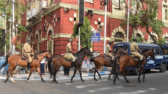 Mounted police personnel patrol on a road in Kolkata Kolkata Police