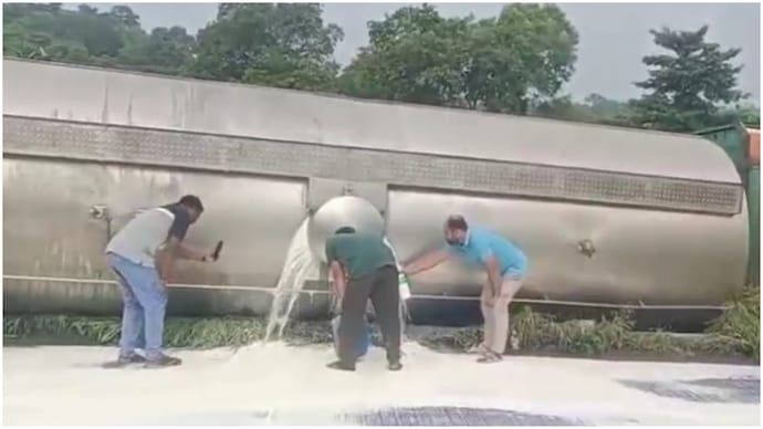 Locals rush with bottles to collect milk as tanker overturns on Maharashtra highway Locals rush with bottles to collect milk as tanker overturns on Maharashtra highway