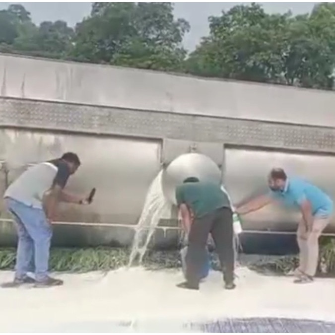 Locals rush with bottles to collect milk as tanker overturns on Maharashtra highway