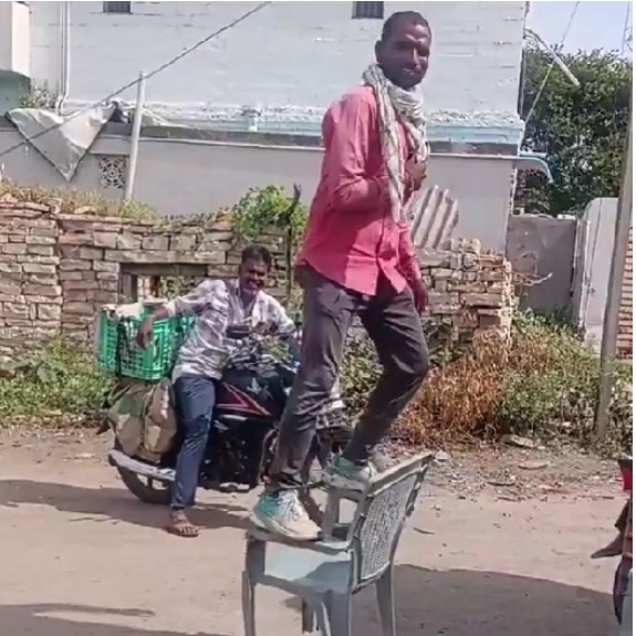 Man selling chairs gives dramatic demonstration to show plastic chair’s sturdiness
