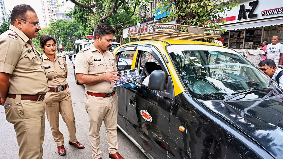 WELL TRAVELLED: Mumbai driver being checked by RTO squad over Marathi language requirement, Aug. 20. (Photo: IANS)