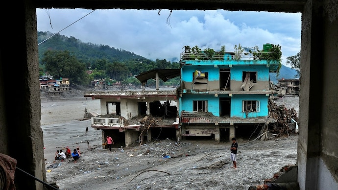 People next to damaged buildings near the Trishuli River, following the deadly flash floods and a mudslide, in Devighat, Nuwakot district, Nepal. (Photo: Reuters) Nepal flood tragedy