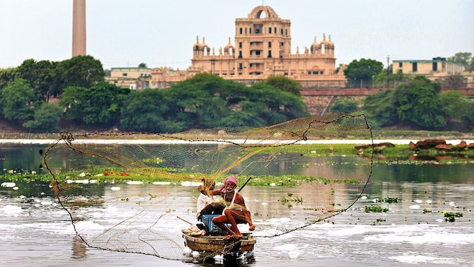 FLOATING VOTE: A fisherman on the Gomti in Lucknow. (Photo: ANI)