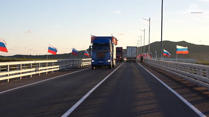 Trucks drive along a road during a ceremony opening the first road bridge between Russia and North Korea across the Tumen River. (Photo: Reuters) Trucks drive along a road during a ceremony opening the first road bridge between Russia and North Korea across the Tumen River