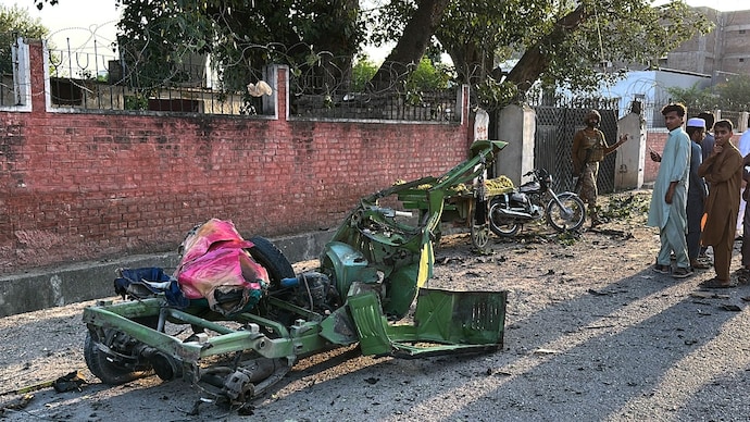 An army soldier and local residents look at the wreckage of auto rickshaw on the site of a powerful bomb exploded at a mosque in Kohat, in northwestern Pakistan on Friday, September 18, 2026. (AP Photo) Pakistan blast
