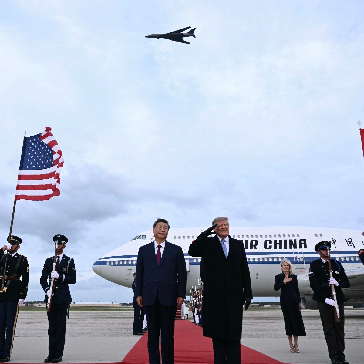US President Donald Trump startled after a B1 bomber flew past during the national anthems while he greeted Chinese President Xi Jinping upon his arrival. (Image: AFP) 
