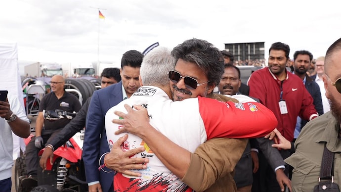 Ajith Kumar and Vijay share warm hug at Silverstone Racing Circuit. Silverstone