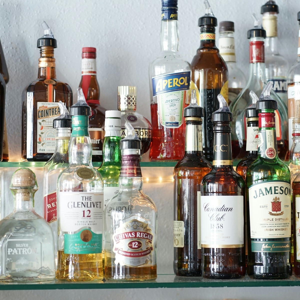 The same neutral spirit, diluted and flavoured differently, is what separates a bottle labelled rum from one labelled whisky on most shelves. (Photo: Unsplash)