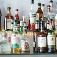 The same neutral spirit, diluted and flavoured differently, is what separates a bottle labelled rum from one labelled whisky on most shelves. (Photo: Unsplash) The same neutral spirit, diluted and flavoured differently, is what separates a bottle labelled rum from one labelled whisky on most shelves. (Photo: Unsplash)