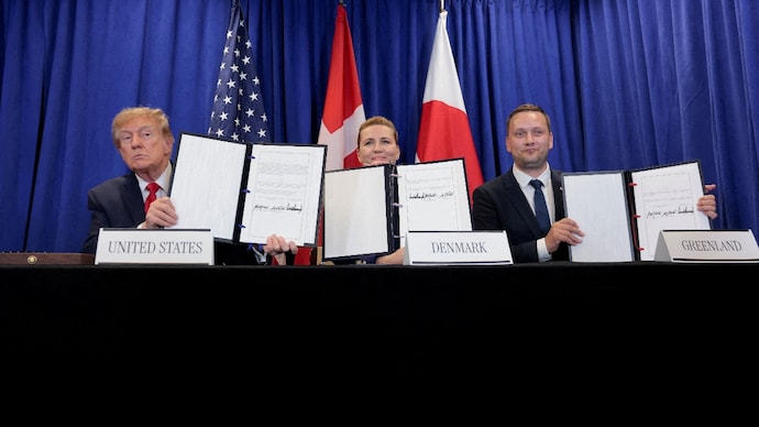 US President Donald Trump, Danish Prime Minister Mette Frederiksen and Greenland Prime Minister Jens-Frederik Nielsen show signed documents during a trilateral signing event regarding a deal on Greenland's security. ( Photo- Reuters)