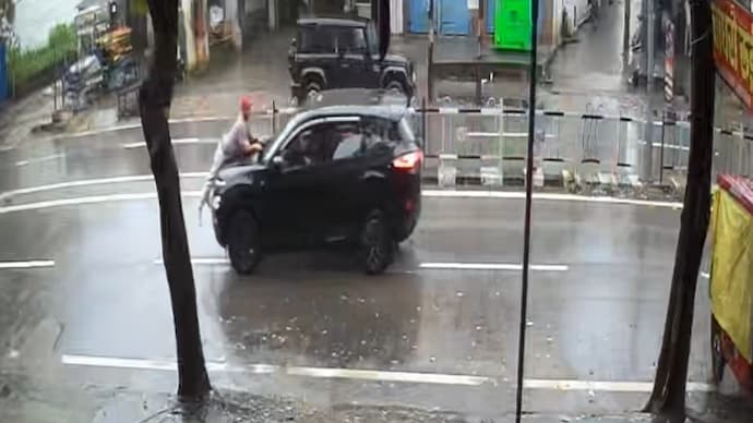 The car then travelled for nearly two kilometres with the man holding on to the bonnet. (CCTV Screengrab) Uttarakhand Collision