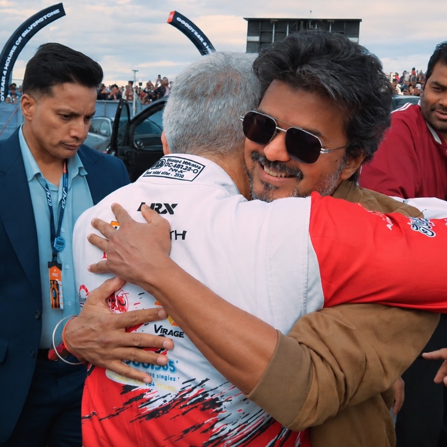 Vijay hugs actor Ajith Kumar at Silverstone Racing Circuit.