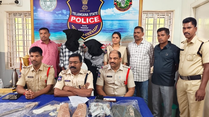 The woman and her alleged lover with Nagarkurnool police after their arrest in her husband's murder case Wife, lover arrested for murder of Nagarkurnool hotelier over affair, property row