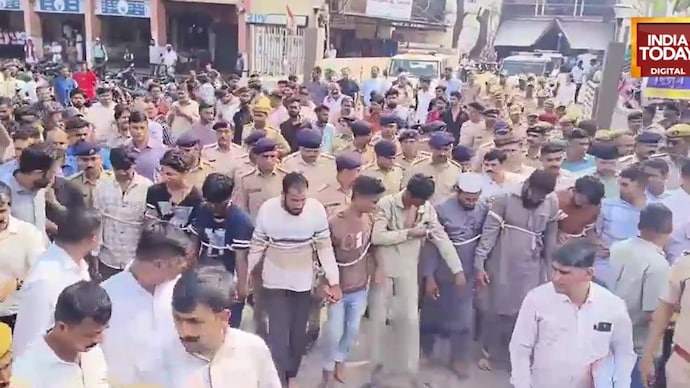 Police parade the nine adult accused through Gujarat’s Songadh town under tight security after a communal clash triggered by an Instagram comment led to stone-pelting at a house. 10 arrested after communal tension erupts over social media comment in Gujarat