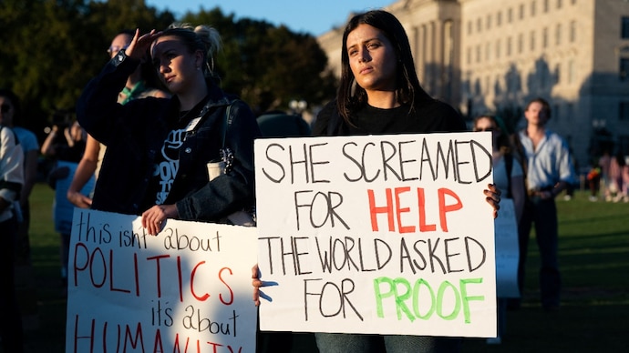 Demonstrators gather during a "Stop Sexual Violence" protest as part of US rallies being held in the wake of the Cornell University rape allegations, at the Washington Monument in Washington, DC. (Reuters)