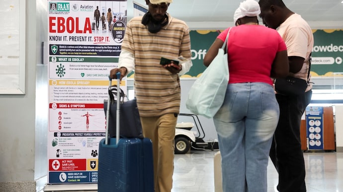 Travellers next to a banner displayed by a health screening station at Murtala Muhammed Airport following reports of an Ebola case in Nigeria, in Lagos, Nigeria, October 22, 2026. ( Photo- Reuters)