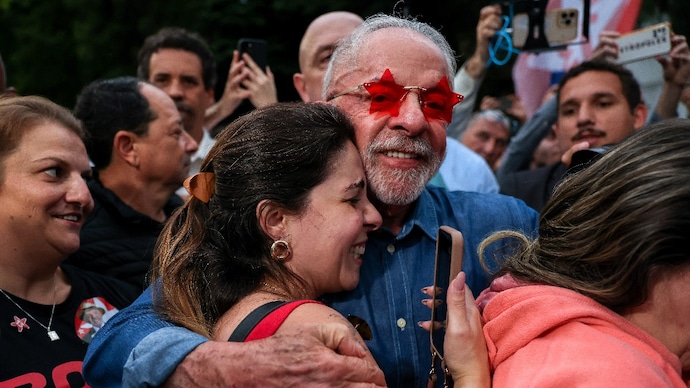Brazilian President Luiz Inacio Lula da Silva, the Workers' Party (PT) candidate for presidential re-election, embraces a supporter outside his residence (Photo- Reuters)