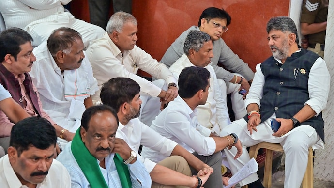 Karnataka Chief Minister DK Shivakumar with his cabinet colleagues stage a 'dharna' on the premises of the Chief Electoral Officer's office. (Image: PTI) Karnataka Chief Minister DK Shivakumar with his cabinet colleagues stage a 'dharna' on the premises of the Chief Electoral Officer's office. (Image: PTI)