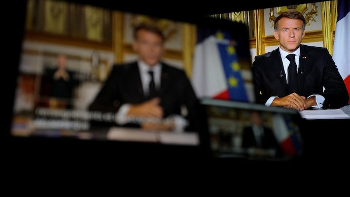 French President Emmanuel Macron appears on screen as he makes a television address to the nation a day after clashes during a national day of demonstrations against the cost of living and rising fuel prices, near Marseille, France. ( Photo- Reuters)