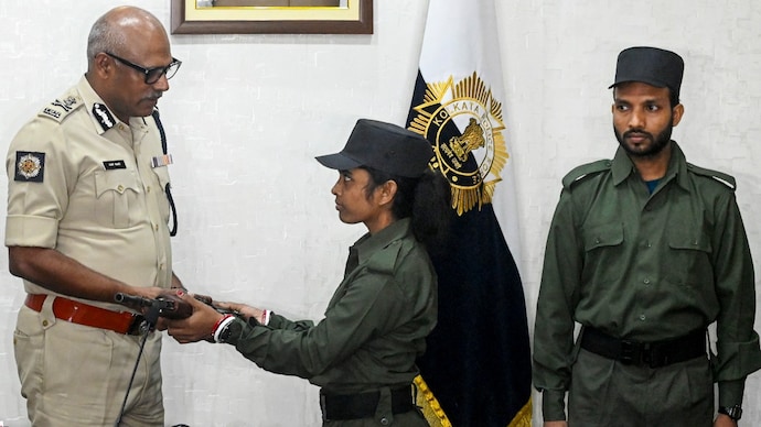 Maoist Malati surrenders her weapon before Kolkata Police Commissioner Ajay Kumar Nand along with Maoist Mangal. (Photo: PTI) Maoist Malati surrenders her weapon before Kolkata Police Commissioner Ajay Kumar Nand along with Maoist Mangal. (Photo: PTI)