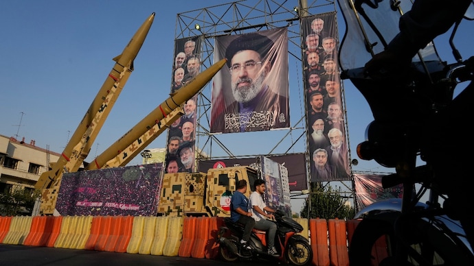 Motorbikes drive past Iranian missiles and banners in Tehran Motorbikes drive past Iranian missiles and banners in Tehran