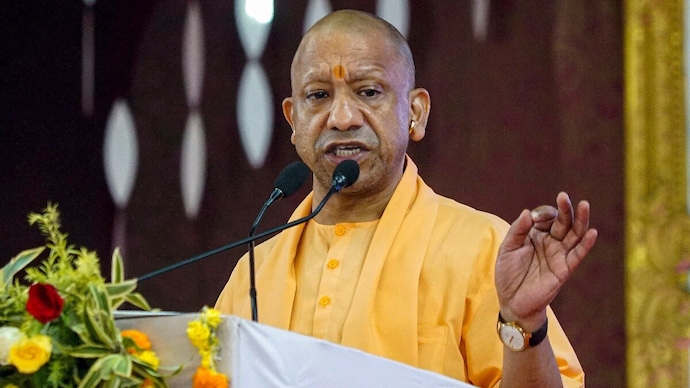 Uttar Pradesh Chief Minister Yogi Adityanath addresses a programme to honour sanitation workers in Varanasi on Thursday. (Photo: PTI)
