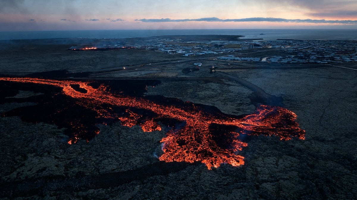 Drone footage Iceland volcano in Grindavik lava surrounding houses